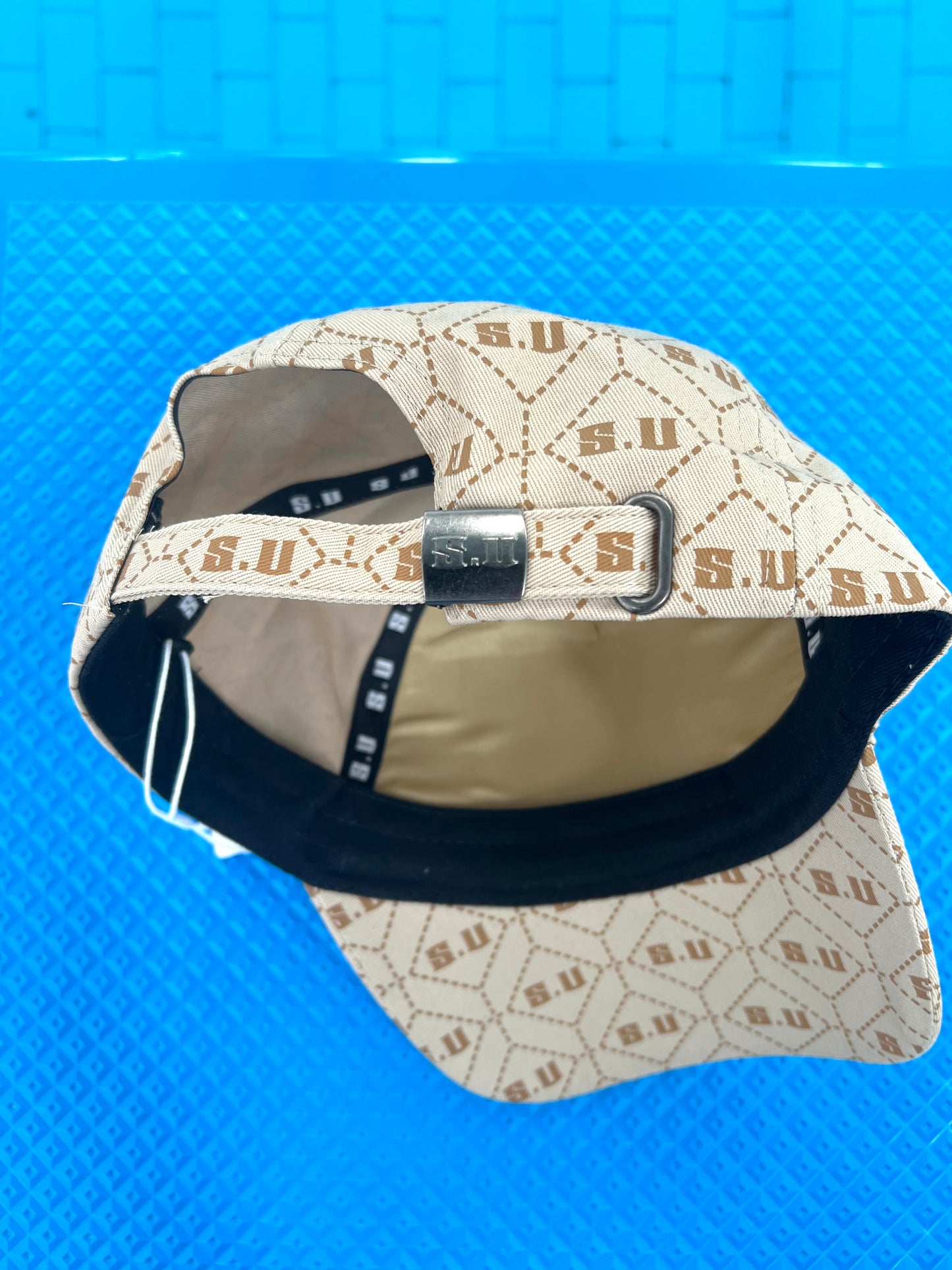 Beige Patterned Baseball Cap with “S.U” Logo